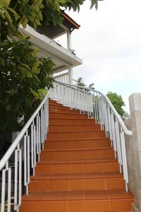 an orange staircase leading up to a house at Minh Kha Hotel in Mui Ne