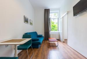 een woonkamer met een blauwe bank en een tafel bij Bravo in Zagreb