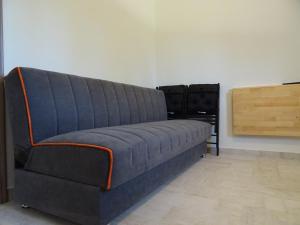 a blue couch sitting in a living room at Dimitra Apartments in Kanali