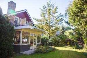 a house with a balcony on the side of it at Bed and Breakfast Hoorn in Hoorn