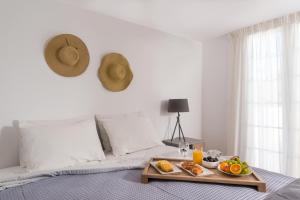 a tray of food sitting on top of a bed at Damma Beachfront Luxury Villa in Kamari