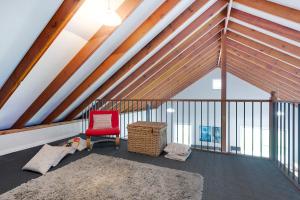 
a room with a wooden floor and a large window at Bush Retreat With Private Pool in Narooma
