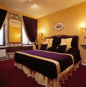 a bedroom with a large bed and a large window at Grand Hôtel Dechampaigne in Paris