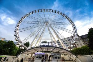a large ferris wheel in the middle of a city at Mercure Budapest City Center in Budapest