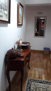 a wooden table in a room with a mirror at Apartment in Portela near the Airport in Lisbon