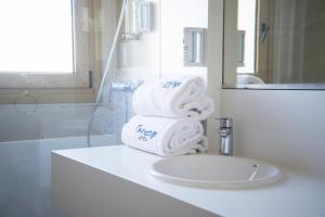 a bathroom with a sink, toilet and bath tub at Prestige Mar y Sol in Roses
