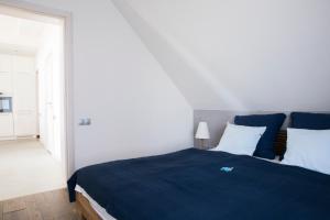 Łóżko lub łóżka w pokoju w obiekcie Apartamenty Port Ustka