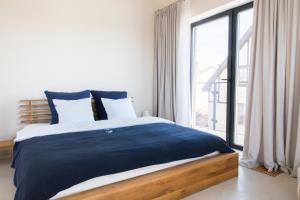 Łóżko lub łóżka w pokoju w obiekcie Apartamenty Port Ustka