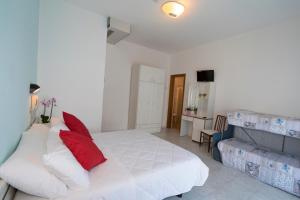 Postel nebo postele na pokoji v ubytování Hotel Giannella