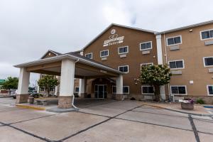 a hotel with a parking lot in front of it at EverSpring Suites in Bismarck