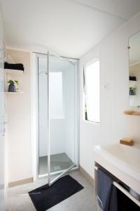 a bathroom with a glass shower and a sink at Lake Park in Berlare