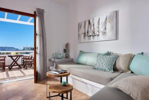 a living room with a couch and a table at Mirabeli Apartments & Suites in Pollonia