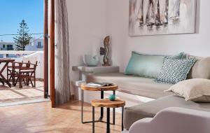a living room with a couch and a table at Mirabeli Apartments & Suites in Pollonia