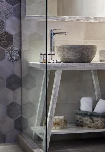 a bathroom with a sink and a glass shower at Mirabeli Apartments & Suites in Pollonia