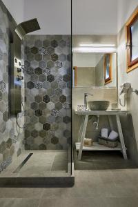 a bathroom with a shower and a sink at Mirabeli Apartments & Suites in Pollonia