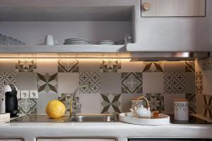 a kitchen with a sink and a counter top at Mirabeli Apartments & Suites in Pollonia