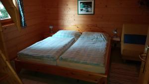 トゥルラッハー・ヘーエにあるAppartements Zirbenalmのログキャビン内のベッドルーム1室(ベッド2台付)