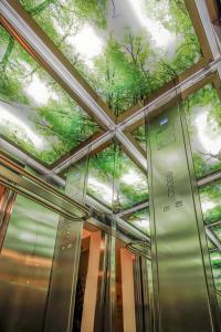 a ceiling in a building with trees on it at Venis Boutique Hotel in Bucharest