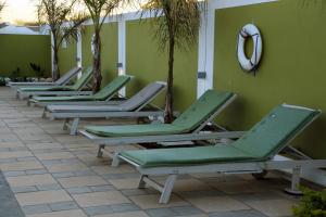 a row of chaise lounges are lined up against a wall at Travelodge in Gaborone +44 photos