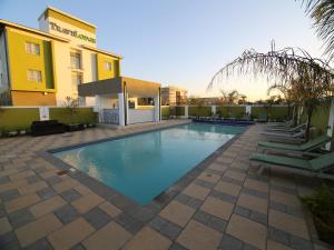 a swimming pool in front of a building at Travelodge in Gaborone