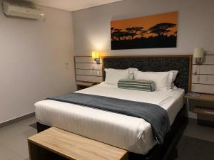 a bedroom with a large bed in a room at Travelodge in Gaborone