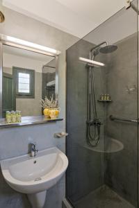a bathroom with a sink and a shower at Dioni Hotel in Skiros +30 photos
