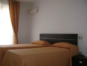 A bed or beds in a room at Residence Montegrappa