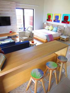 a living room with a table and two stools at Belle Crique B2/B3 in Tamarin