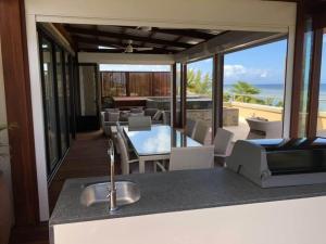 a kitchen with a sink and a view of the ocean at Belle Crique B2/B3 in Tamarin