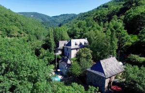 una vista aerea di una casa nel mezzo di una foresta di L'Ancienne Ecole a Entraygues-sur-Truyère