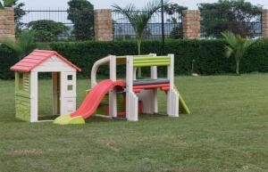 a set of playground equipment in a yard at Buvi Lodge Limited in Entebbe