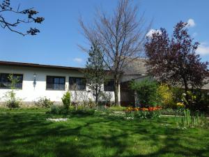 a house with a yard with flowers in front of it at Gästehaus Gabriel in Illmitz