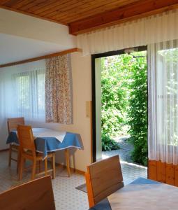 a room with a table and chairs and a sliding glass door at Gästehaus Gabriel in Illmitz