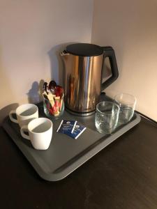 a tray with a coffee pot and cups on a table at Bjork Guesthouse in Laugarvatn