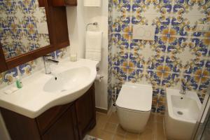 a bathroom with a sink and a toilet at Domus Cuseni in Taormina +16 photos