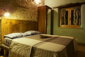 a bedroom with a bed in a room at Casa della Casa in San Severino Marche