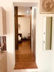 a hallway leading into a room with a mirror at Cris Apartments in SantʼAmbrogio di Valpolicella
