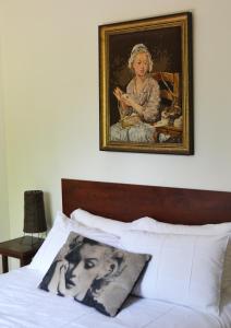 a picture of a woman sitting on top of a bed at At Olive Guesthouse in Vanderbijlpark