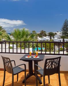 
a table with chairs and a table cloth at H10 Suites Lanzarote Gardens in Costa Teguise
