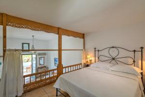 a bedroom with a large bed and a balcony at Dioni Hotel in Skiros