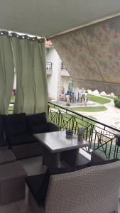 a patio with a table and chairs on a balcony at Sakis in Siviri +10 photos