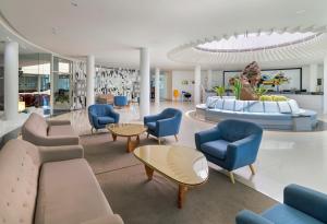 a lobby with couches and chairs and a table at H10 Suites Lanzarote Gardens in Costa Teguise