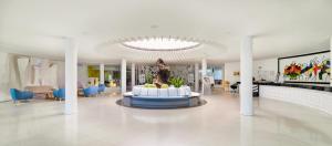 a lobby with a fountain in the middle of a building at H10 Suites Lanzarote Gardens in Costa Teguise