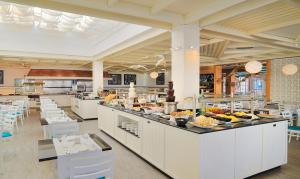 a restaurant with a buffet line with food on display at H10 Suites Lanzarote Gardens in Costa Teguise