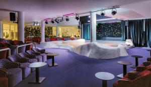 a room with a stage with chairs and tables at H10 Suites Lanzarote Gardens in Costa Teguise