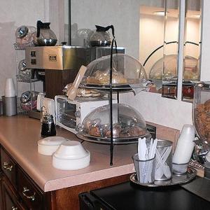 a kitchen with a counter with food on a shelf at Executive Inn & Suites - Covington in Covington