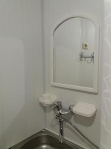a bathroom with a sink and a mirror at Гостевой дом in Odesa