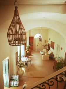 a view of a living room with a chandelier at Pousada Linda Castellabate in Santa Maria di Castellabate