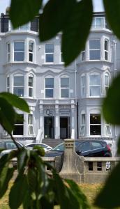 a white building with cars parked in front of it at Q8 Boutique Hotel in Portsmouth