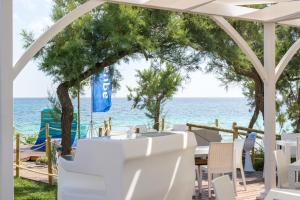 a gazebo with a table and chairs and the ocean at AquariumResidence in San Pietro in Bevagna